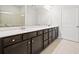 Bright bathroom featuring a double vanity, tile floor and large mirror at 218 Hickory Commons Way, Canton, GA 30115