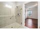 Bright bathroom featuring glass shower with tile surround, and view to an adjacent bedroom at 218 Hickory Commons Way, Canton, GA 30115