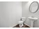 Clean and modern half bathroom featuring a pedestal sink and wood-look flooring at 218 Hickory Commons Way, Canton, GA 30115