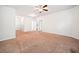 Spacious carpeted bedroom with neutral walls, ceiling fan, and two doorways at 218 Hickory Commons Way, Canton, GA 30115