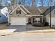 Charming home with stone accents, a two-car garage, and a neatly maintained front lawn at 218 Hickory Commons Way, Canton, GA 30115