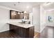 Bright kitchen with granite island, modern appliances, and dark wood cabinetry at 218 Hickory Commons Way, Canton, GA 30115