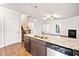 Kitchen island with granite countertops and stainless steel appliances with open living space at 218 Hickory Commons Way, Canton, GA 30115