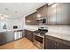 Modern kitchen featuring stainless steel appliances, granite countertops, and hardwood floors at 218 Hickory Commons Way, Canton, GA 30115