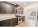 Well-lit kitchen boasts stainless steel appliances, granite counters, and ample cabinet space at 218 Hickory Commons Way, Canton, GA 30115