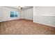 Large living room with plush carpeting, neutral walls, and bright window at 218 Hickory Commons Way, Canton, GA 30115