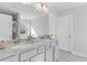 Bathroom featuring double vanity with granite countertops, large mirror and white cabinets at 3786 Lockaby Way, Lawrenceville, GA 30044