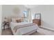 Bright bedroom with neutral tones, a decorative mirror, and a view of the outdoors at 3786 Lockaby Way, Lawrenceville, GA 30044