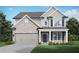 Charming two-story home featuring a brick and siding facade, attached garage, and well-manicured lawn at 3786 Lockaby Way, Lawrenceville, GA 30044