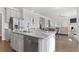 Open-concept kitchen with stainless appliances, large island, and easy access to the dining area at 3786 Lockaby Way, Lawrenceville, GA 30044