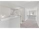 Bright upstairs landing with neutral carpet, white trim, and wrought iron banister at 3786 Lockaby Way, Lawrenceville, GA 30044