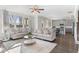 Spacious living room with hardwood floors, fireplace, and windows overlooking scenic view at 3786 Lockaby Way, Lawrenceville, GA 30044