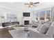 Comfortable living room with a fireplace, large windows, and modern decor at 3786 Lockaby Way, Lawrenceville, GA 30044