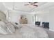 Spacious main bedroom featuring a tray ceiling, carpet flooring, sitting area, and dresser at 3786 Lockaby Way, Lawrenceville, GA 30044