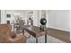 Modern office with a wooden desk, leather chair, and an open view to the dining area at 3786 Lockaby Way, Lawrenceville, GA 30044