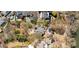 An aerial view reveals a leafy neighborhood, real estate, mature trees, and a waterfront at 3847 Sweet Bottom Dr, Duluth, GA 30096