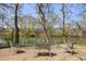 Riverfront backyard seating area features mature trees and lovely views at 3847 Sweet Bottom Dr, Duluth, GA 30096