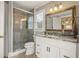 Stylish bathroom features a glass shower, white vanity with marble countertop, and an ornate mirror at 3847 Sweet Bottom Dr, Duluth, GA 30096