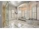 Spa-like bathroom with a soaking tub, walk-in shower, and elegant chandelier at 3847 Sweet Bottom Dr, Duluth, GA 30096