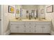Bright bathroom featuring a double vanity with mirrors, and a neutral color scheme at 3847 Sweet Bottom Dr, Duluth, GA 30096
