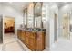 Luxurious bathroom with a double vanity, marble countertop, and walk-in shower at 3847 Sweet Bottom Dr, Duluth, GA 30096