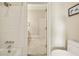 Bathroom featuring white tiles, tub and shower combination, and an open doorway to the next room at 3847 Sweet Bottom Dr, Duluth, GA 30096