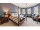 Spacious bedroom boasts a four-poster bed, large seating area, and elegant crown molding at 3847 Sweet Bottom Dr, Duluth, GA 30096