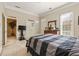 Cozy bedroom featuring light walls, a decorative bedspread, and lots of natural light from the window at 3847 Sweet Bottom Dr, Duluth, GA 30096