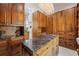 Spacious closet boasts custom wood cabinetry, storage island with marble countertop, and elegant chandelier lighting at 3847 Sweet Bottom Dr, Duluth, GA 30096