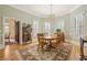 Bright dining room with hardwood floors, natural light, and a classic chandelier, ideal for Gathering meals at 3847 Sweet Bottom Dr, Duluth, GA 30096