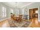 Sunlit dining area with hardwood floors, shuttered windows, and traditional decor, perfect for entertaining guests at 3847 Sweet Bottom Dr, Duluth, GA 30096