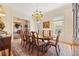 Elegant dining room featuring a chandelier, hardwood floors, and large windows, perfect for hosting gatherings at 3847 Sweet Bottom Dr, Duluth, GA 30096