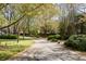 Winding driveway surrounded by mature trees and manicured lawns creating a serene entrance to the property at 3847 Sweet Bottom Dr, Duluth, GA 30096