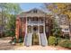 Stately brick home featuring dual staircases, charming balconies, and mature landscaping at 3847 Sweet Bottom Dr, Duluth, GA 30096