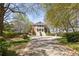 Beautiful front yard with mature trees and circular driveway leading to the grand home at 3847 Sweet Bottom Dr, Duluth, GA 30096