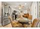 Cozy kitchen features stainless steel appliances, white cabinetry, and a glass table with seating at 3847 Sweet Bottom Dr, Duluth, GA 30096