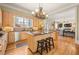 Open-concept kitchen featuring a kitchen island, and lots of cabinets with convenient access to the living room at 3847 Sweet Bottom Dr, Duluth, GA 30096