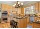 Bright kitchen with stainless steel appliances, a central island with bar seating, and hardwood flooring at 3847 Sweet Bottom Dr, Duluth, GA 30096