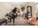 Cozy living room with a piano, vintage decor, plush seating, and a decorative chandelier for a touch of elegance at 3847 Sweet Bottom Dr, Duluth, GA 30096