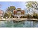 Beautiful backyard with a large inground pool, spa, lush landscaping, and elegant home at 3847 Sweet Bottom Dr, Duluth, GA 30096