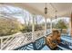 Inviting porch with wooden chairs, classic railings, and a view of the lush greenery at 3847 Sweet Bottom Dr, Duluth, GA 30096