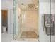 Modern walk-in shower with marble tile, a rain shower head, and a heated towel rack at 3847 Sweet Bottom Dr, Duluth, GA 30096