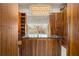 Spacious walk-in closet with custom shelving, a center island, and a stylish chandelier at 3847 Sweet Bottom Dr, Duluth, GA 30096