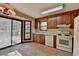 Kitchen featuring wood cabinets, appliances, and sliding glass door to outdoor deck at 3960 Rocmar Dr, Snellville, GA 30039