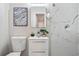 Bathroom with modern vanity, stylish mirror, and beautiful marble-style tiled shower at 1013 Columbia Dr, Decatur, GA 30030