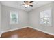 Bright bedroom with hardwood floors and natural light from two windows at 1013 Columbia Dr, Decatur, GA 30030