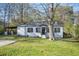 Charming single-story home featuring a manicured lawn, carport, and classic architectural details at 1013 Columbia Dr, Decatur, GA 30030