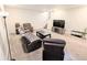 Spacious basement with modern seating, a TV, and workout equipment for recreation at 3655 Brisbane Dr, Marietta, GA 30062