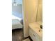 Bathroom with vanity, large mirror and view of a bedroom with ceiling fan at 3655 Brisbane Dr, Marietta, GA 30062