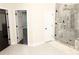 Bathroom with frameless glass shower and white door with black hardware at 3655 Brisbane Dr, Marietta, GA 30062